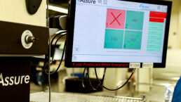 Computer screen showing the results for 4 automated tests in large, colored boxes. 3 are green, showing a passed test, 1 is red, showing a failed test.